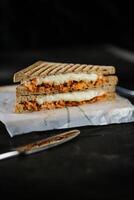 Chicken Tikka Mint Grilled Sandwich isolated on wooden board side view of fast food on dark background photo