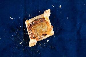 Beef Bacon Puff isolated on blue background top view of savory snack food photo