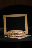 Chicken Tikka Mint Grilled Sandwich isolated on wooden board side view of fast food on dark background photo