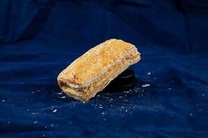 Creamy Chicken Puff isolated on blue background side view of savory snack food photo