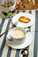 Cream Chicken soup with bread served in bowl isolated on napkin side view of chinese soup photo