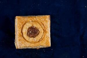 Salmon Wellington Puff isolated on blue background top view of savory snack food photo