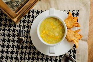 Sweet Corn Chicken Soup served in bowl isolated on napkin top view of chinese soup photo