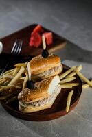 Tuna Egg Sandwich with fries and mayonnaise dip served in wooden board isolated on dark background side view of breakfast food photo