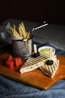 Grilled Chicken Sandwich with fries bucket served in wooden board isolated on napkin side view of breakfast food photo