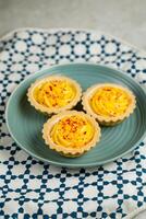 Lemon Tart muffin cup cake served in plate isolated on napkin side view of cafe baked food on background photo