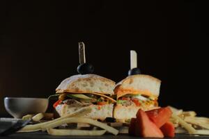 Spicy Southwest Chicken Sandwich with fries and mayonnaise dip served in tray isolated on dark background side view of breakfast food photo