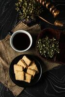 Crunchy cookies biscuits served in plate with black coffee isolated on table side view of american cafe baked food photo