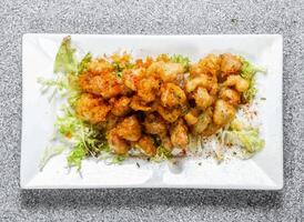 Spicy Crispy Chicken Cartilage topping with chilli powder served in dish isolated on background top view of hong kong food photo