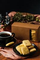 Crunchy cookies biscuits served in plate with black coffee isolated on table side view of american cafe baked food photo