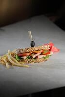 Smoked Chicken Sandwich with fries and mayonnaise dip isolated on dark background side view of breakfast food photo