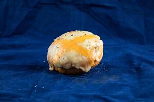 Crispy Chicken Bun isolated on blue background side view of savory snack food photo