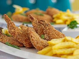 FRIED SHRIMPS with french fries served in dish isolated on table closeup top view of grilled seafood photo