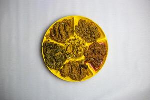 Assorted Bhorta Bhaj or bhaji with aloo, eggplant, baingan, tomato vorta served in plate isolated on background top view of bangladeshi, indian and pakistani traditional spicy food photo