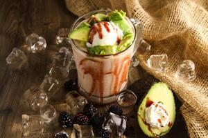 Avocado and mulberry lava drink served in disposable glass isolated on table side view of healthy drink photo