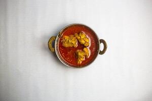 Chicken karahi bhuna korma masala with gravy served in karahi isolated on background top view of bangladeshi, indian and pakistani traditional spicy food photo