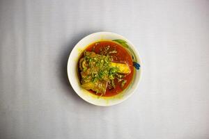 Grour beef nalli Nihari served in karahi isolated on background top view of bangladeshi, indian and pakistani traditional spicy food photo