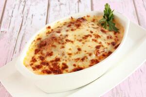 Baked Beef Lasagna Served in dish isolated on table closeup top view of italian food photo