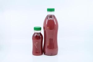 Fresh pomegranate juice bottle served in bottle isolated on background side view of healthy morning juice drink photo