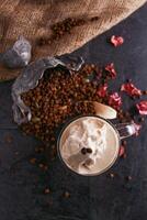 Mocha caramel with coffee beans served in glass isolated on table top view of healthy drink photo