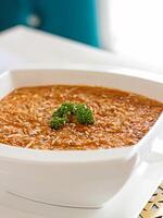 CHICKEN RISOTTO topping with coriander closeup served in pot isolated on table side view of arabic food photo