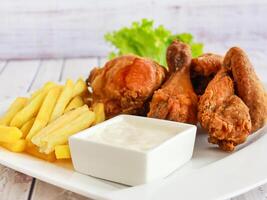 CHICKEN Broast BROASTED with fried and dip sauce platter served in dish isolated wooden table top view of deep fired fastfood photo