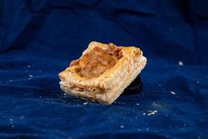 Tandoori Chicken Cheese puff isolated on blue background side view of savory snack food photo