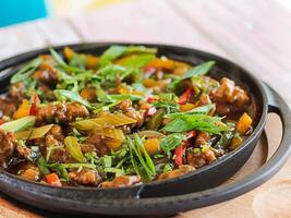 Mixed SIZZLING Chicken, Beef, Shrimps served in dish isolated on wooden table top view of spicy food photo