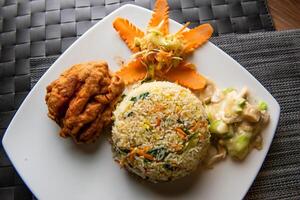 fried rice, fried chicken and salad served in dish top view of fastfood photo