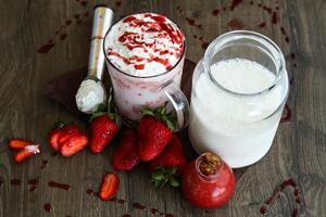 Strawberry vanilla ice cream shake served in glass isolated on table side view of healthy drink photo