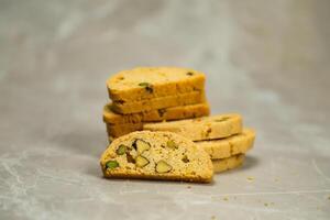 Tasty cookies biscuits include pistachio served on background side view of bakery item photo