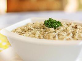 Shrimps RISOTTO topping with coriander closeup served in pot isolated on table side view of arabic food photo