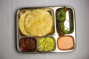 Beef Seekh kabab with Lucchi, chuntney, sauce and chilli dip served in thali platter isolated on background top view of bangladeshi food set menu photo