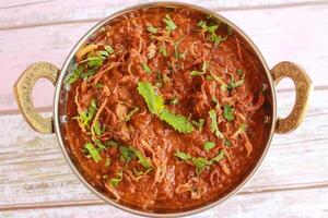 Special Chicken Masala Gravy with Fried Onion served in karahi isolated on table closeup top view of indian spices food photo