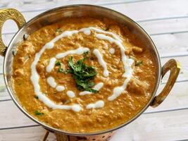 Chicken Korma Masala Gravy with Butter Cream served in karahi isolated on table closeup top view of indian spices food photo