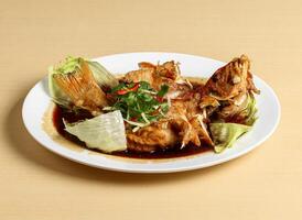 Deep fried grouper served in dish isolated on background top view singapore food photo