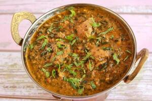 Chicken Palak Korma Masala Gravy served in karahi isolated on table closeup top view of indian spices food photo