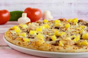 Hawaiian Pizza closeup topping with capsicum, mushroom, tomato and olives served in dish isolated on table side view of arabic fastfood photo