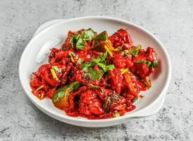 chilli chicken served in dish isolated on background top view of desi indian food photo