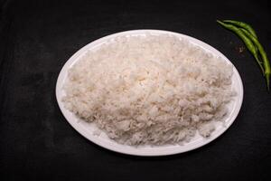 Plain Steamed Rice served in dish isolated on dark background top view indian spices, bangladeshi and pakistani food photo