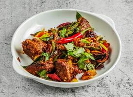 mutton varuval dry or lamb pepper served in dish isolated on background top view of desi indian food photo