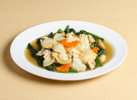 braised abalone and spinach soup served in dish isolated on background top view singapore food photo