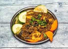 coriander prawn roast served in dish isolated on wooden table top view of indian spicy food photo