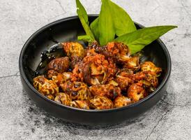 salted snails or oc huong muoi tac, botoi served in dish isolated on grey background top view of singapore seafood photo