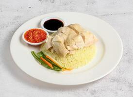 steamed chicken rice with chilli and soy sauce served in dish isolated on banana leaf top view of singapore food photo