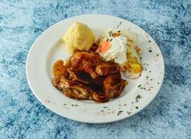 grilled Chicken steak with mashed potato and egg served in plate isolated on background top view of italian food photo