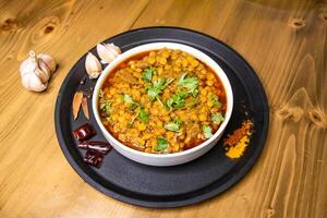 dal chana and mezbani gosht served in dish isolated on wooden background top view indian spices, bangladeshi and pakistani food photo