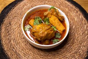 Beef Nali Nihari or Nolar Jhol served in dish isolated on wooden background side view indian spices, bangladeshi and pakistani food photo