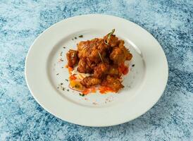 chicken bites served in plate isolated on background top view of italian food photo