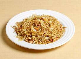 fried noodles with shrimp and honey glazed pork served in dish isolated on background top view singapore food photo